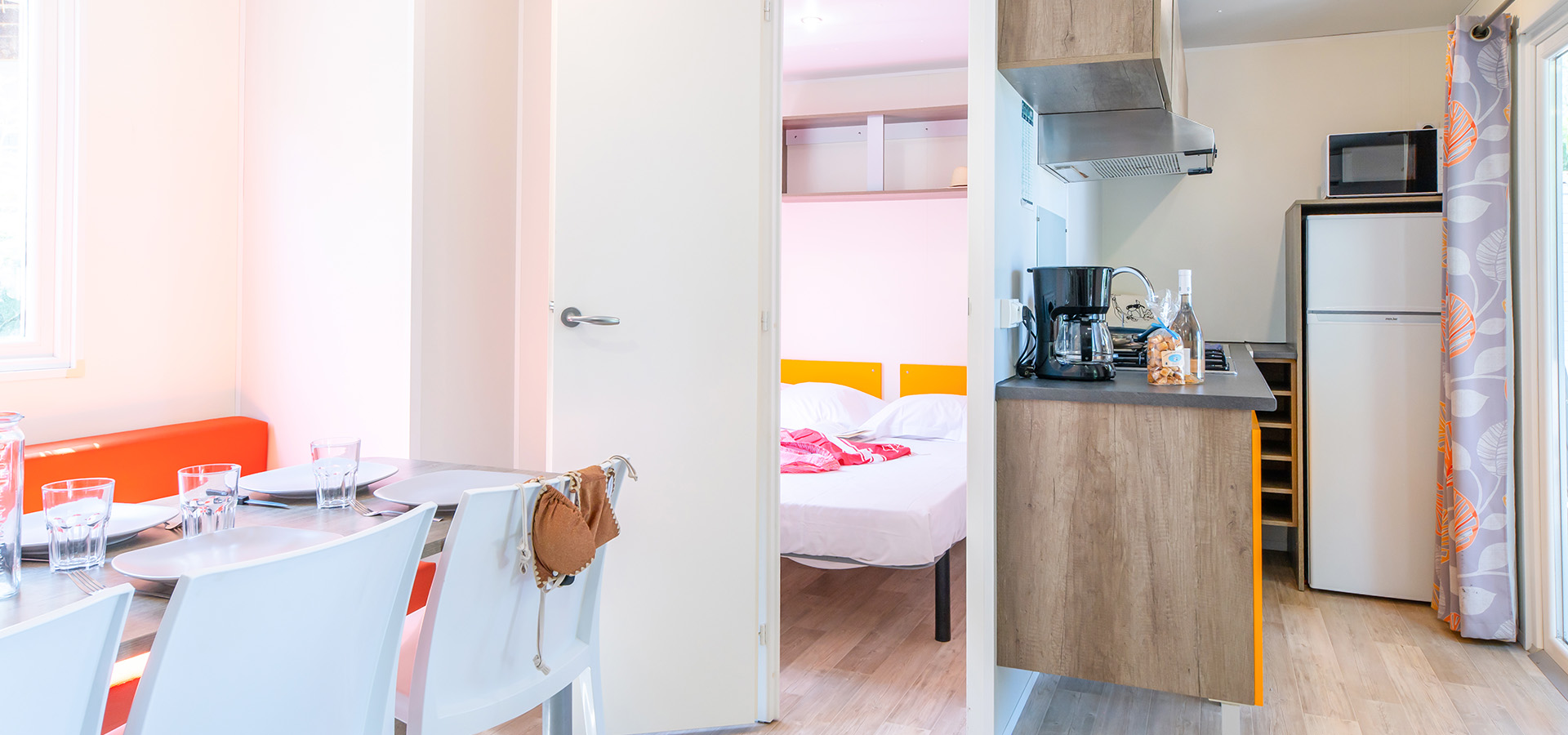 Camping san damiano bungalow declik table banquette cuisine chambre parentale