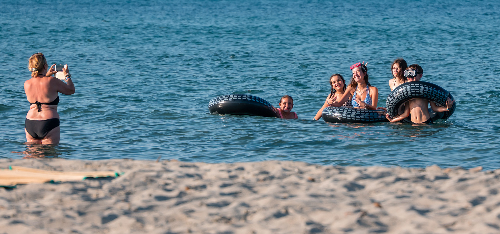 Camping san damiano plage famille qui se fait prendre en photo dans la mer